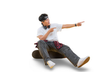 A young man is sitting on a skateboard and pointing to something with both hands on png background