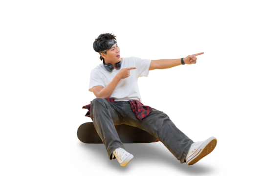 A young man is sitting on a skateboard and pointing to something with both hands on png background - Powered by Adobe