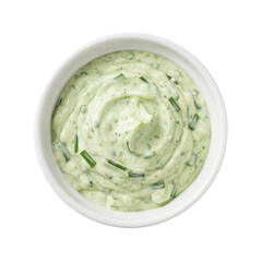 Obraz premium Creamy green herb sauce in a white bowl, ready for serving with fresh vegetables or dishes