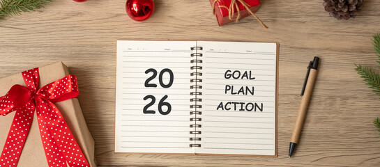 2026 Goal Plan Action with notebook, Christmas gift and pen on wood table. Xmas, Happy New Year, Resolution, To do list, start and Strategy concept
