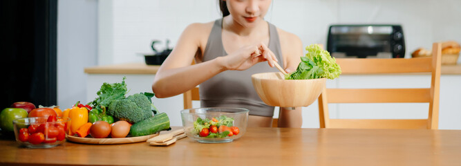 Woman Preparing Healthy Meal in Kitchen, Fit Woman Making Smoothie and salad with Fresh Ingredients at home