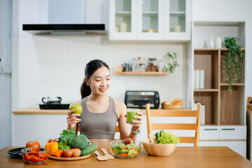 Woman Preparing Healthy Meal in Kitchen, Fit Woman Making Smoothie and salad with Fresh Ingredients at home. Active healthy lifestyle, clean eating concept