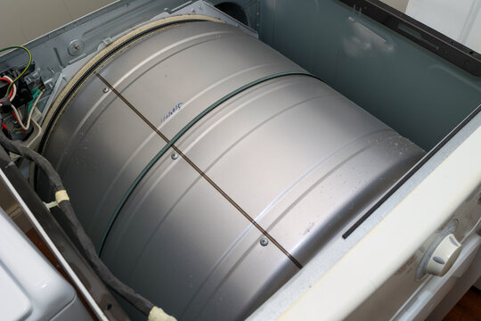 A broken heating element on a dryer being repaired 
