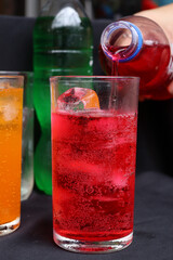 Pouring  soft drink and ice in glass
