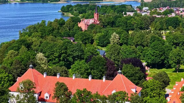 Birzai castle and church in background by Sirvena lake. Aerial view