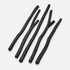 Five dark, slender, slightly curved sticks, resembling charred branches, arranged on a light background