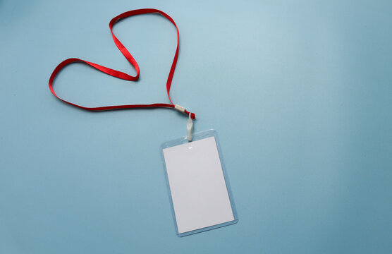 Red lanyard with blank badge isolated on blue background	