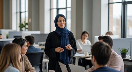 A young woman in a hijab confidently leads a diverse team meeting in a modern, open-plan .