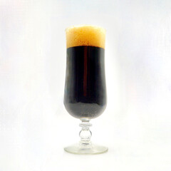 A glass of porter beer isolated against a white background.