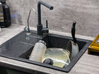 Dirty Dishes in a Modern Kitchen Sink