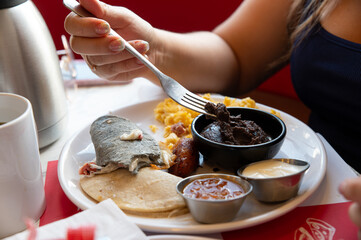Traditional Central American Breakfast with Scrambled Eggs, Plantains and Black Beans