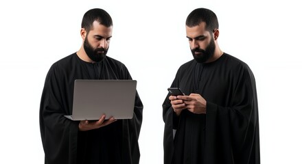 A man in dark robes uses a laptop and a mobile phone, showcasing modern technology alongside traditional attire.