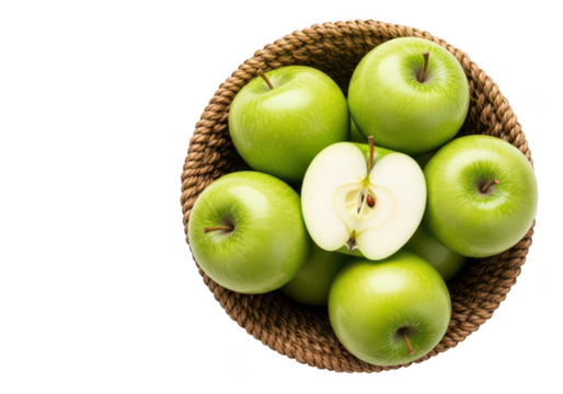 A woven basket filled with bright green apples one apple cut in half fruit food