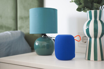 Colorful speaker and decor on a modern bedside table