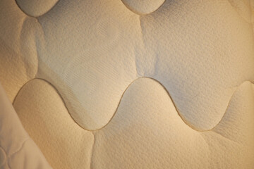 Close-up of a textured mattress surface at nighttime