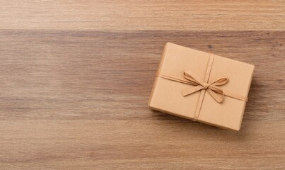 Brown Gift Box with Ribbon on Wooden Background