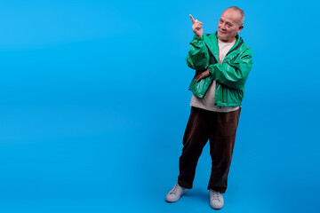 Portrait Of Older Asian Male Wear Green Jacket Pointing To Side