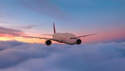 Airplane flying over tropical sea at sunset