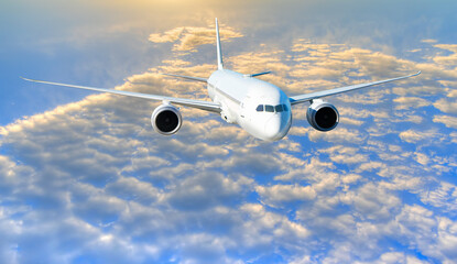 White passenger airplane flying in the sky amazing clouds in the background at sunset - Travel by air transport