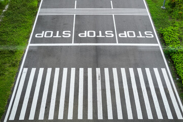 Overhead view of a zebra crossing with three bold 