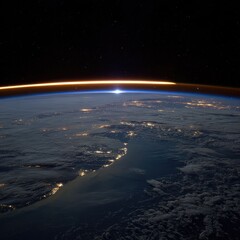 Earth's horizon glows with sunrise