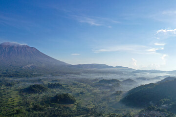 Misty Morning Over Rice Fields and Mount Agung Volcano