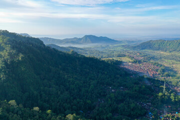 Forest-Covered Mountain Slopes Casting Shadows Over the Valley