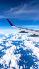 Airplane wing over a vast expanse of clouds