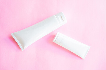 white bottle cosmetic on pink background