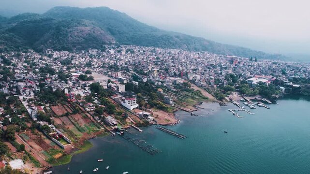 Santiago Atitlan, Guatemala, Drone Shot of Town and Port on Lake Atitlan on Misty Morning