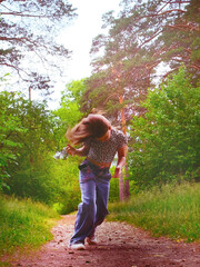 Happy young girl enjoying walking, dancing, jumping. Freestyle. Freedom and carefree....