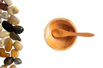 frame made of spoon on wooden bowl with pebbles stone isolated on white