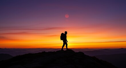 Silhouette of Hiker on Mountain Peak at Sunset with Vivid Sky