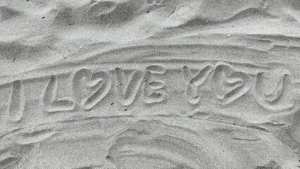 Write I love you on the sand 
