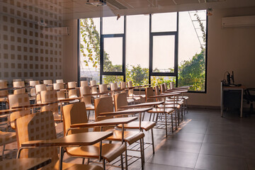 Empty Modern Classroom with Desks Chairs and Large Window Interior View