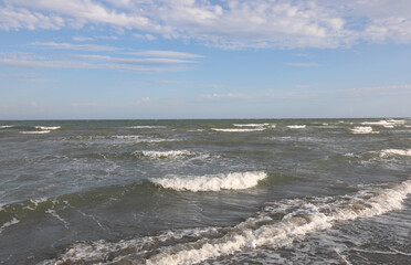 sea below with waves and sky above with clouds ideal background with concept of nature relaxation and summer vacation