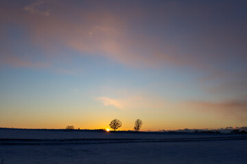 The sun sets in the snow