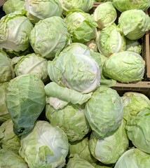 basket of many green cabbage vegetables for sale at the greengrocers stall