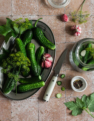 Ingredients for cooking pickled canned cucumbers on a stone background, top view