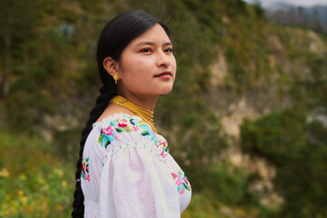 Indigenous otavalo woman wearing traditional clothes in ecuadorian andes mountains