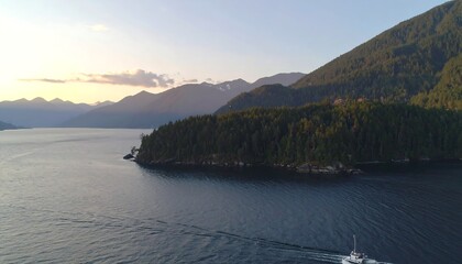 Serene sunset over a forested island in a calm bay, a sailboat glides peacefully on the water