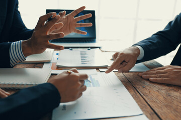 Business team analyzing financial charts and graphs during a meeting, discussing company strategy...