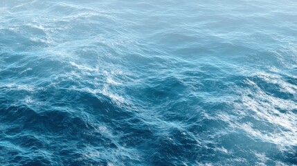 Turquoise water glimmers under a clear sky, with gentle waves creating a serene atmosphere that invites relaxation and calmness.