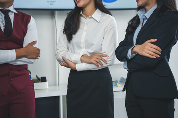 Business professionals are standing with arms crossed, conveying confidence, teamwork, and...