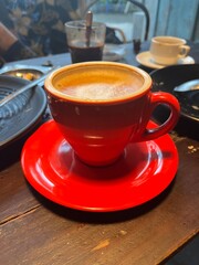 someone enjoying coffee in a striking red cup—highlighting contrast, warmth, and a bold lifestyle...