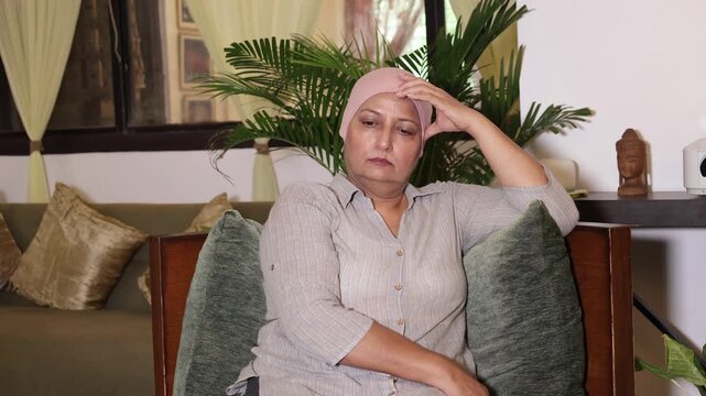 Pensive Lonely Indian mature female patient with cancer problem thinking about her illness at home. Sadness and negative emotion. Health care. 4k