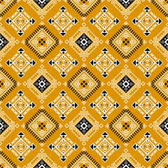 A seamless geometric pattern with diamond shapes in mustard, black, and white, featuring tribal and ethnic motifs.