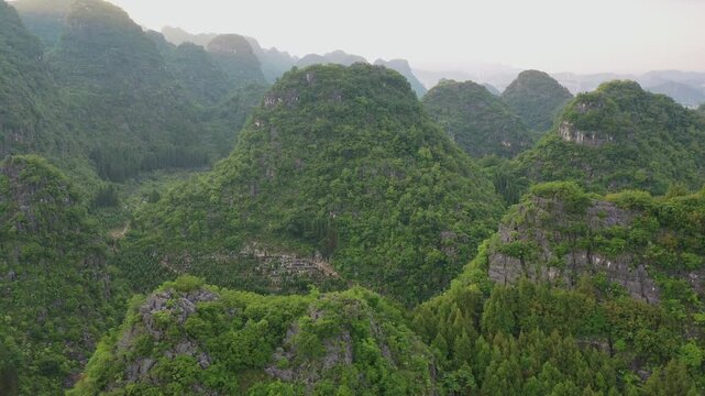 Explore stunning aerial views of Wanfenglin attractions in Guizhou, showcasing breathtaking landscapes and lush greenery