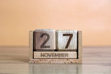 Wooden perpetual calendar showing the 27th of november