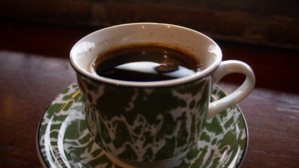 Traditional Black Coffee in Green Enamel Cup